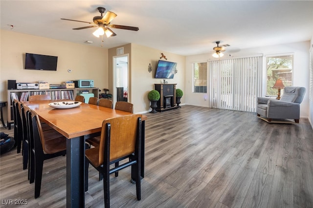 dining space featuring ceiling fan, a healthy amount of sunlight, and hardwood / wood-style flooring