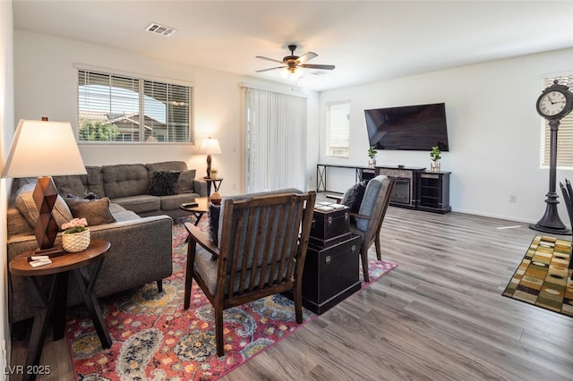 living room featuring ceiling fan and hardwood / wood-style floors