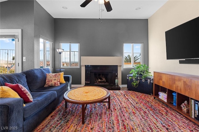 living room with ceiling fan and a wealth of natural light