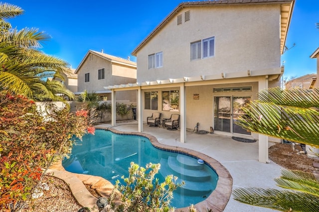 rear view of property featuring a patio area