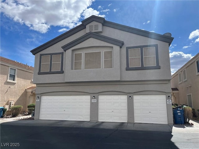 view of front of house featuring stucco siding and a garage