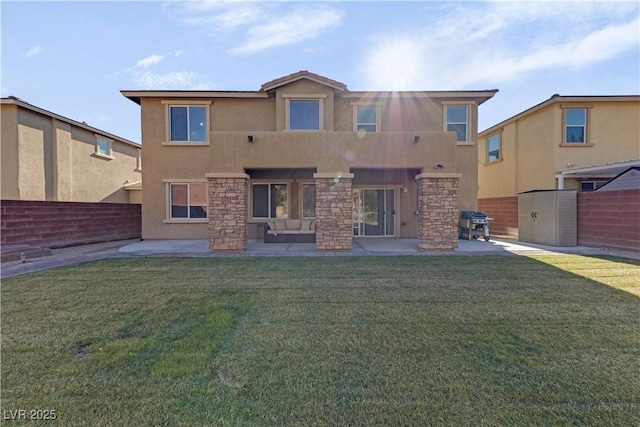 rear view of property featuring a yard and a patio area