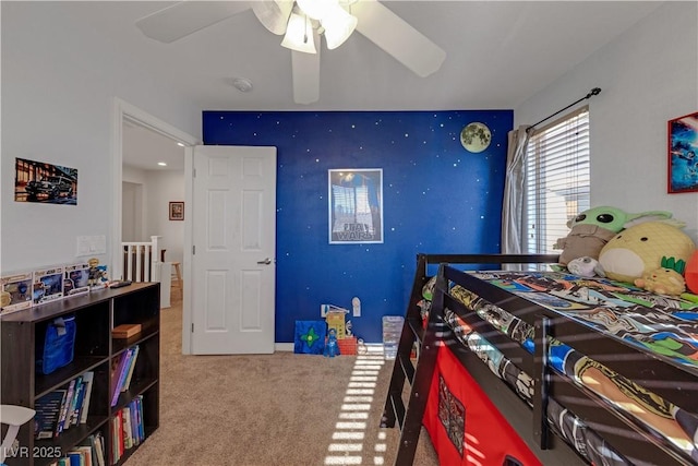 bedroom featuring ceiling fan and carpet