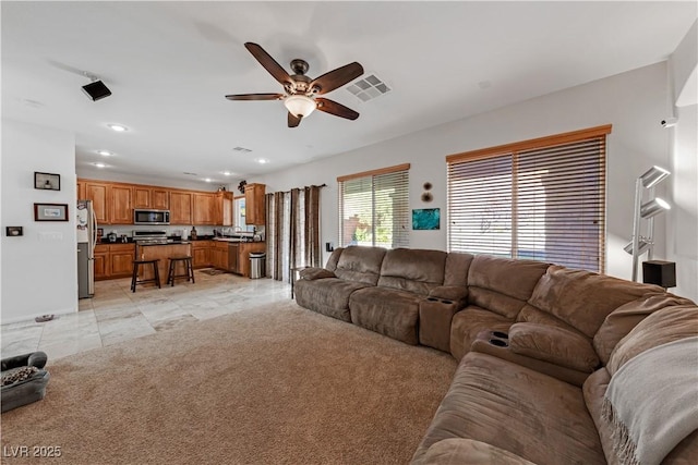 living room with ceiling fan and light carpet