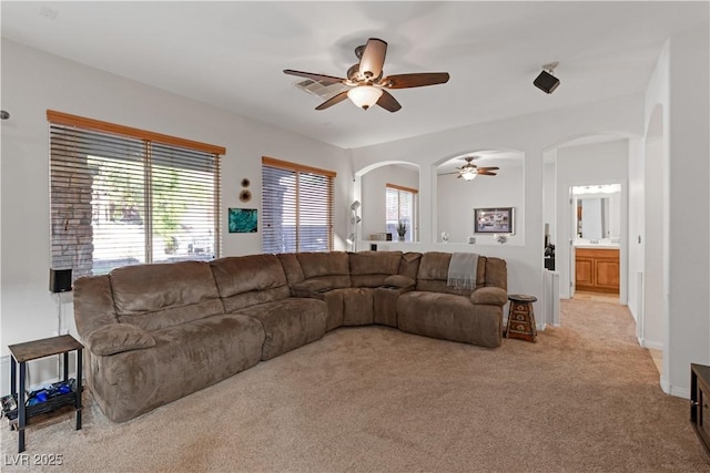 carpeted living room featuring ceiling fan