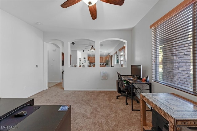 office area with ceiling fan and light carpet