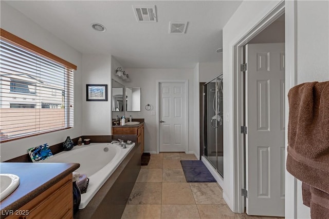 bathroom featuring tile patterned flooring, separate shower and tub, and vanity