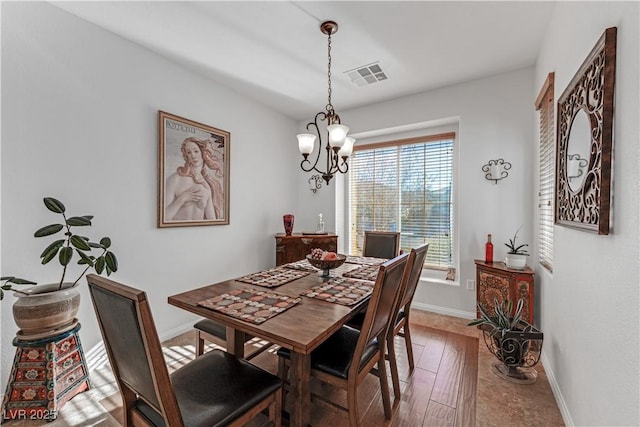 dining area with a chandelier and hardwood / wood-style floors