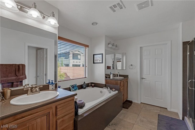 bathroom featuring vanity, tile patterned floors, and plus walk in shower