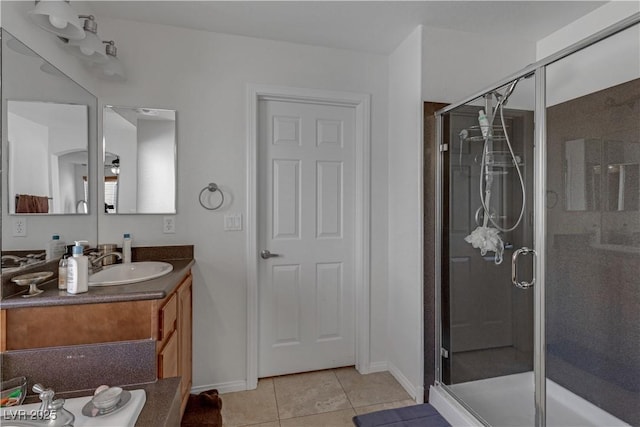 bathroom featuring a shower with door, vanity, and tile patterned flooring