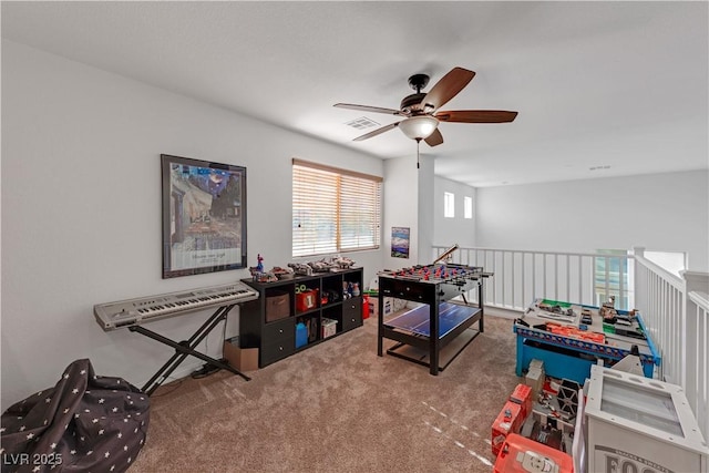 playroom featuring ceiling fan and carpet