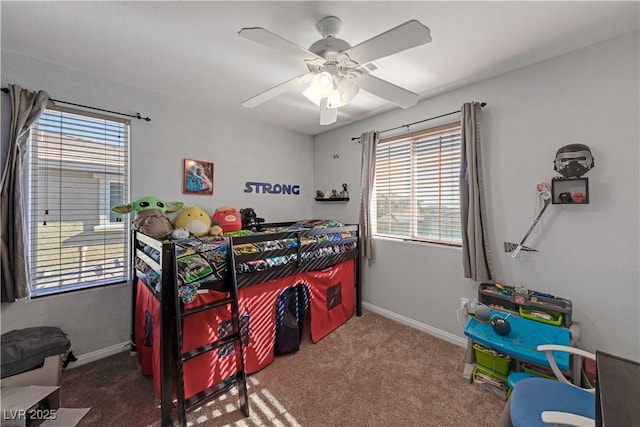 carpeted bedroom with ceiling fan and multiple windows