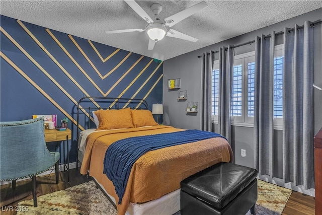 bedroom with wood-type flooring, a textured ceiling, and ceiling fan