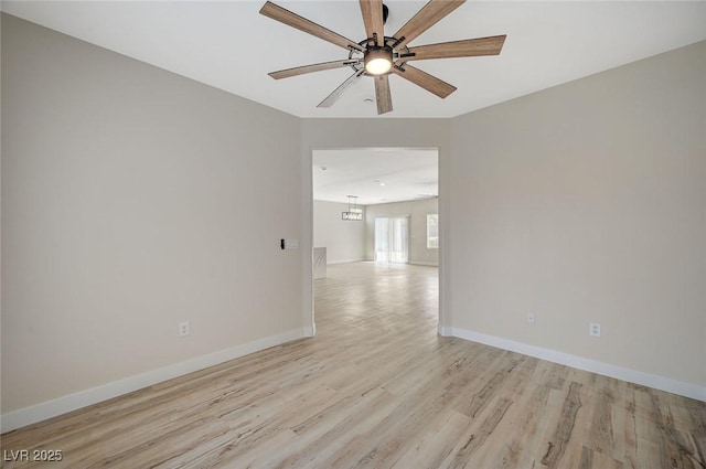 empty room with ceiling fan and light hardwood / wood-style floors