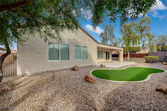 rear view of house featuring a patio