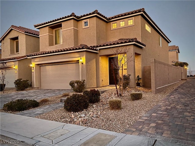 mediterranean / spanish house featuring a garage