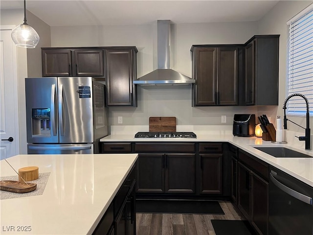 kitchen featuring stainless steel refrigerator with ice dispenser, black dishwasher, dark wood-type flooring, wall chimney range hood, and sink