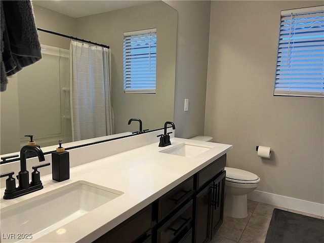 bathroom featuring toilet, vanity, a shower with curtain, and tile patterned flooring