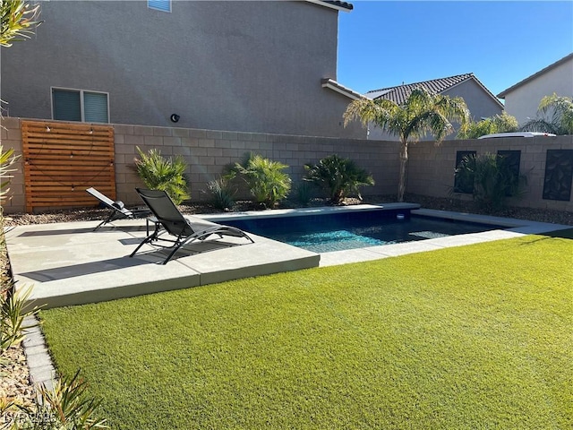 view of swimming pool with a patio area and a yard