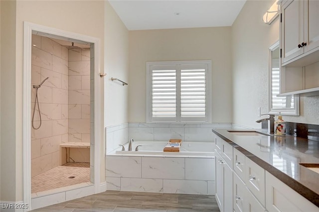 bathroom featuring vanity and separate shower and tub