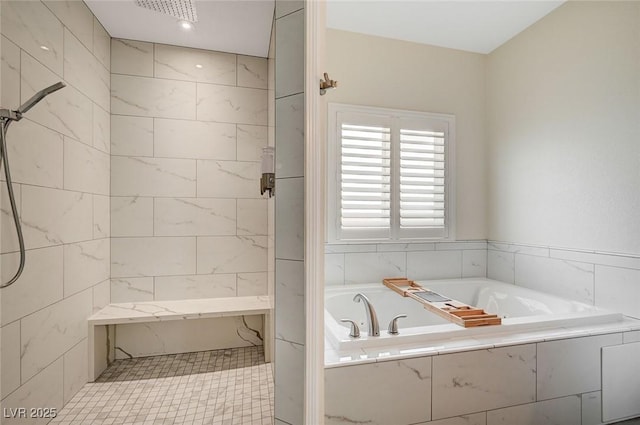 bathroom featuring shower with separate bathtub