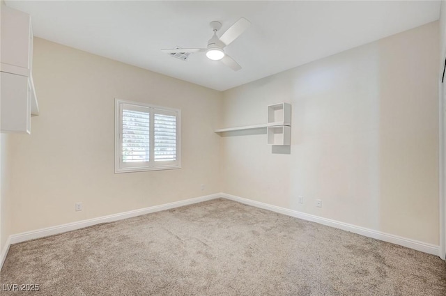 spare room with ceiling fan and carpet