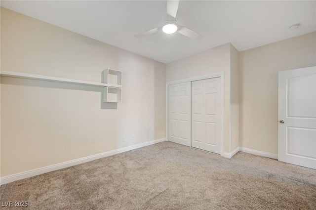 unfurnished bedroom with ceiling fan, a closet, and light carpet