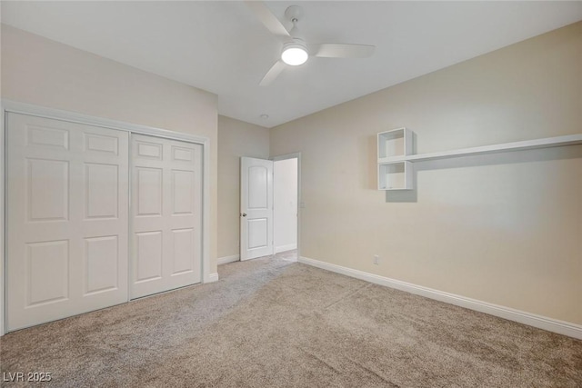 unfurnished bedroom featuring light carpet, ceiling fan, and a closet