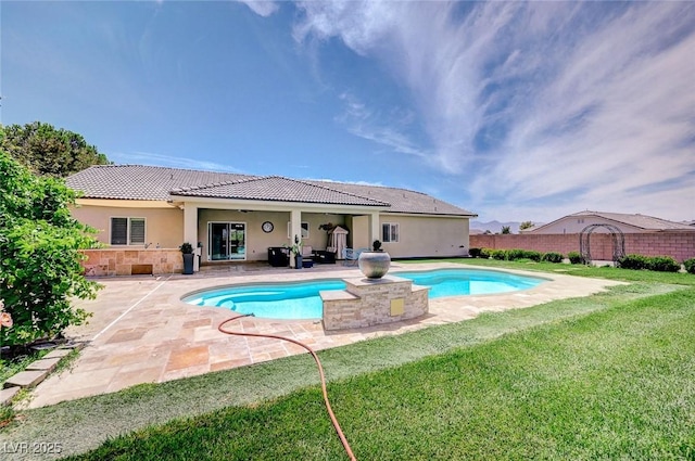 view of pool with a lawn and a patio area