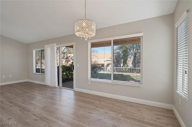 interior space featuring light hardwood / wood-style floors and a notable chandelier