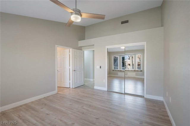 unfurnished bedroom with ceiling fan, a closet, and light hardwood / wood-style flooring