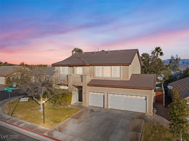 view of front property featuring a garage and a balcony