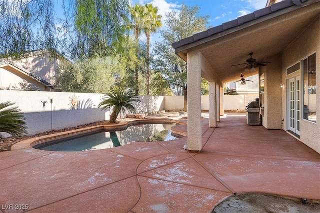 view of pool with ceiling fan, a patio area, and a grill