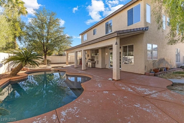 view of swimming pool with grilling area and a patio area