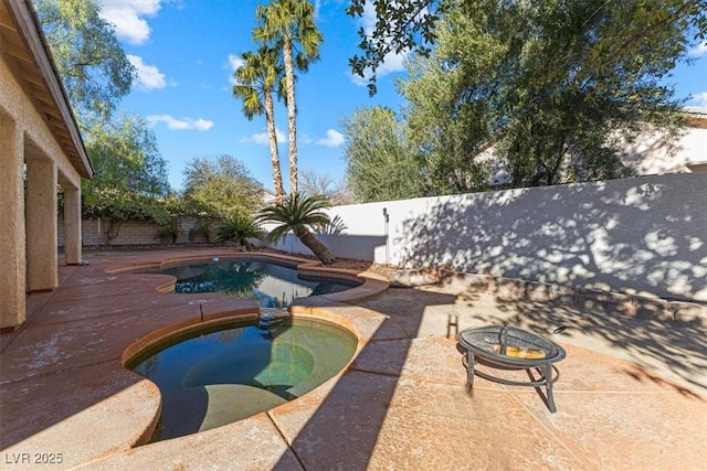 view of pool featuring an outdoor fire pit, a patio, and an in ground hot tub