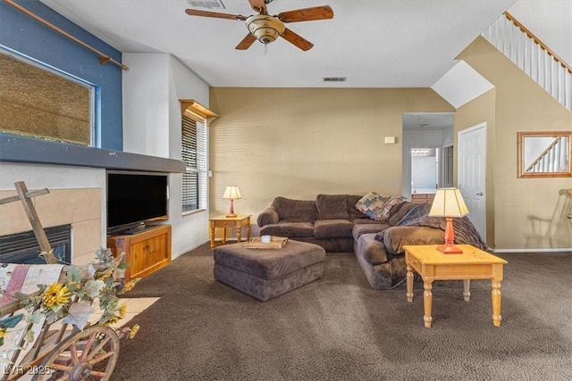 living room with ceiling fan, carpet, lofted ceiling, and a fireplace