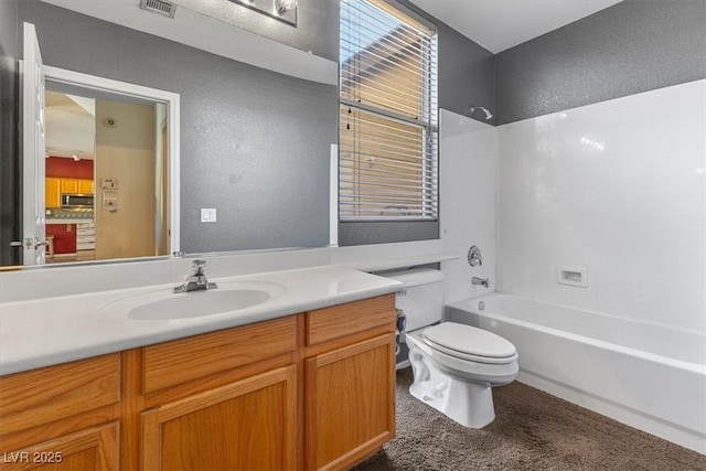 full bathroom featuring toilet, vanity, and shower / washtub combination