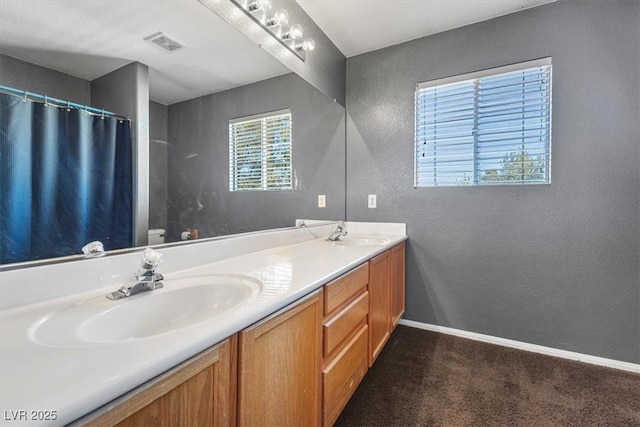 bathroom featuring toilet, vanity, and a shower with shower curtain