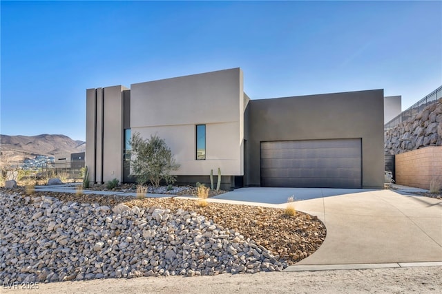 view of front of house with a garage and a mountain view