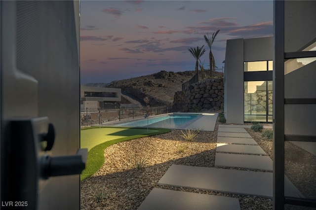 pool at dusk with a mountain view