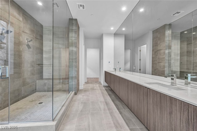 bathroom with tile patterned floors, vanity, and a shower with door