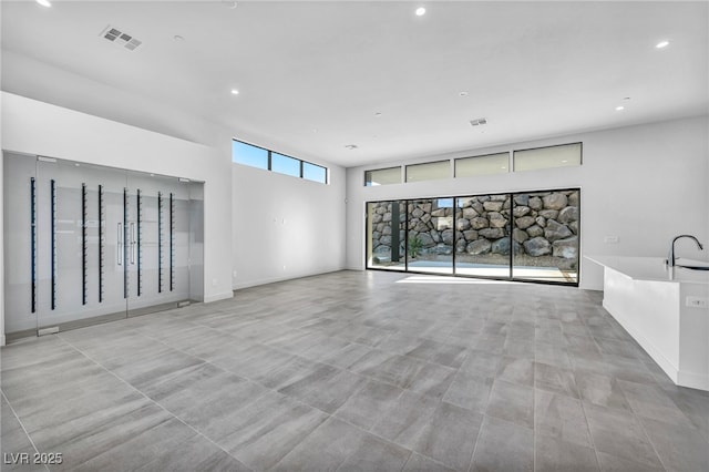 unfurnished living room with sink