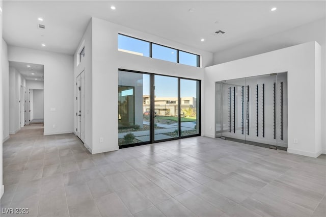 unfurnished room with a towering ceiling