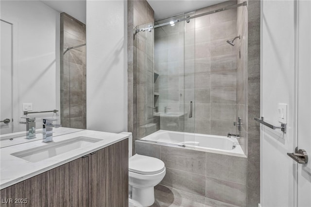 full bathroom with vanity, toilet, and combined bath / shower with glass door