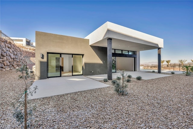 rear view of property featuring a patio area