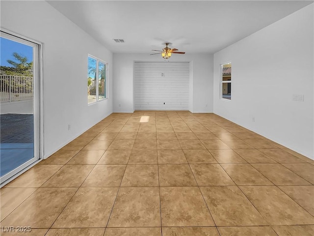 unfurnished room featuring light tile patterned floors and ceiling fan