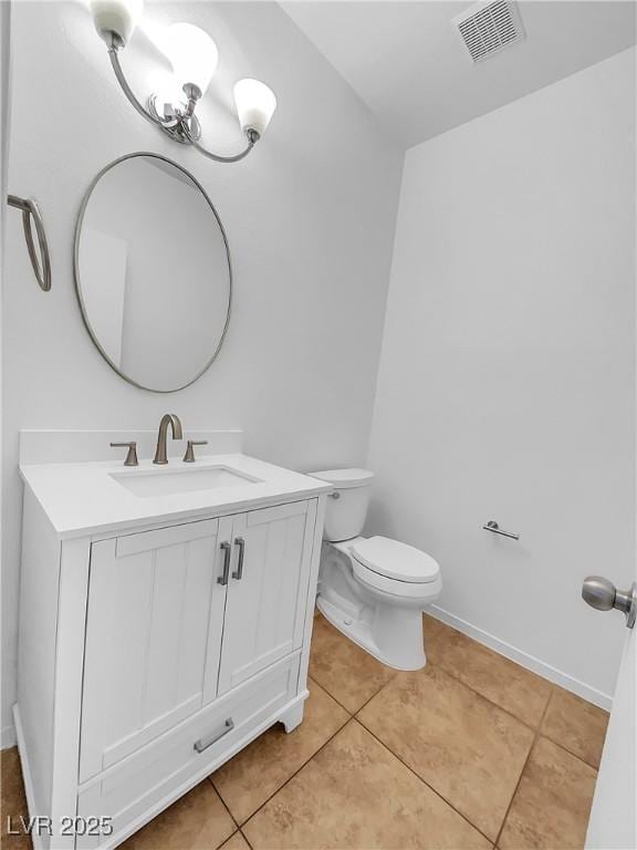 bathroom featuring toilet, tile patterned flooring, and vanity