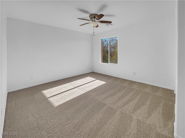 spare room with ceiling fan and carpet floors