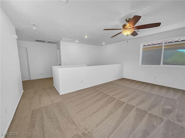 unfurnished room with light carpet and ceiling fan