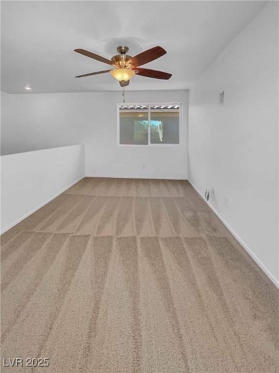 interior space featuring ceiling fan and carpet